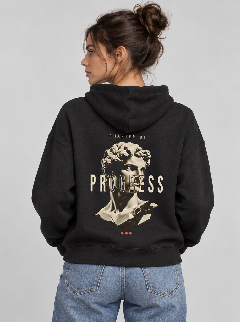 Female model wearing the black Unfinished Sculpture Hoodie, back view
