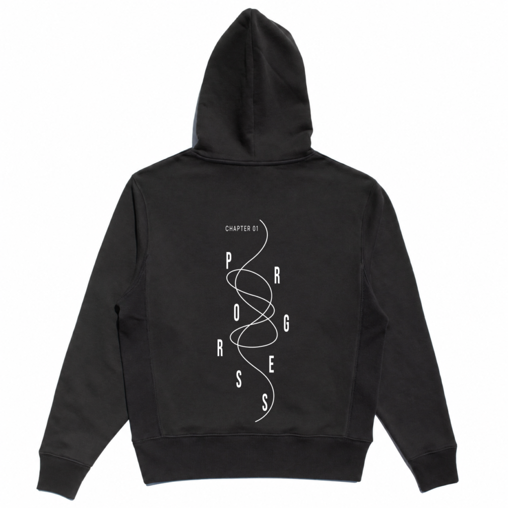 Back view of the black Controlled Chaos Hoodie with PROGRESS lettering and looping-line artwork.